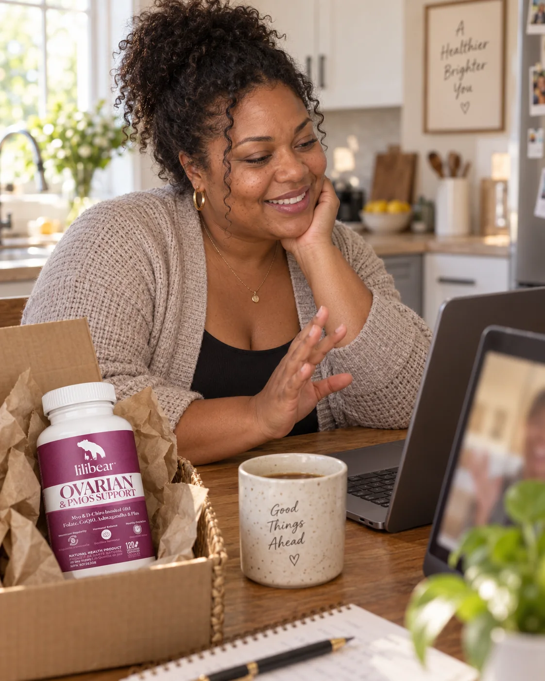 Woman on a video call unboxing LiliBear® Ovarian & PMOS Support in her kitchen.